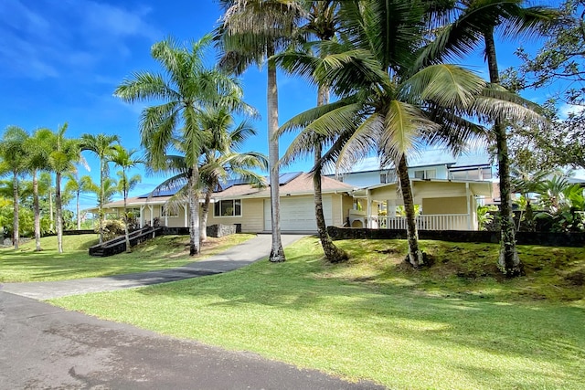 view of front of property with a front lawn and a garage