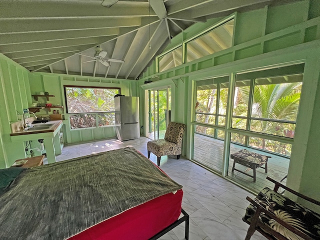 bedroom with vaulted ceiling, sink, access to outside, and stainless steel fridge