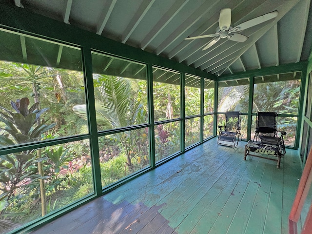 unfurnished sunroom with ceiling fan and plenty of natural light