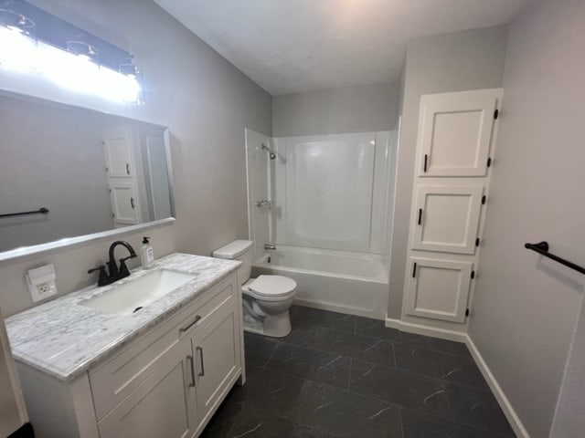 full bathroom featuring shower / bathing tub combination, vanity, toilet, and tile patterned floors