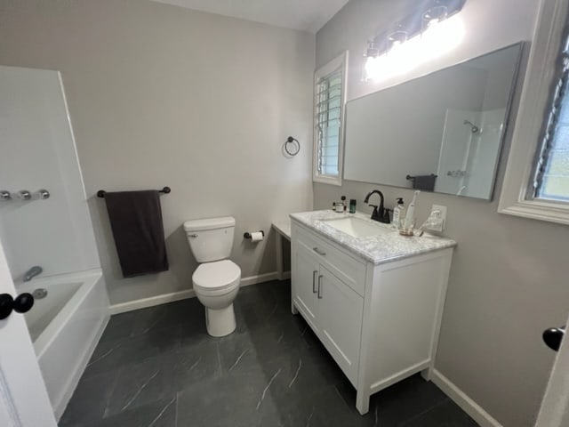 full bathroom with shower / tub combination, vanity, and toilet