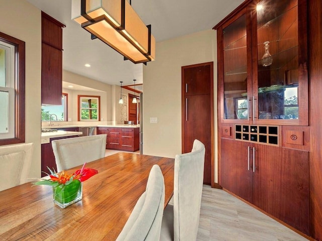 dining room with light hardwood / wood-style flooring and sink