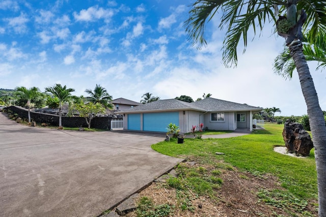 single story home featuring a front lawn and a garage