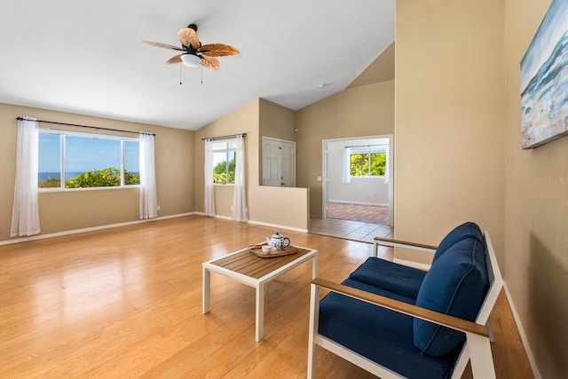 sitting room featuring vaulted ceiling, a wealth of natural light, light wood-type flooring, and ceiling fan