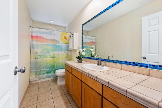 bathroom featuring vanity, a shower with curtain, toilet, and tile patterned floors