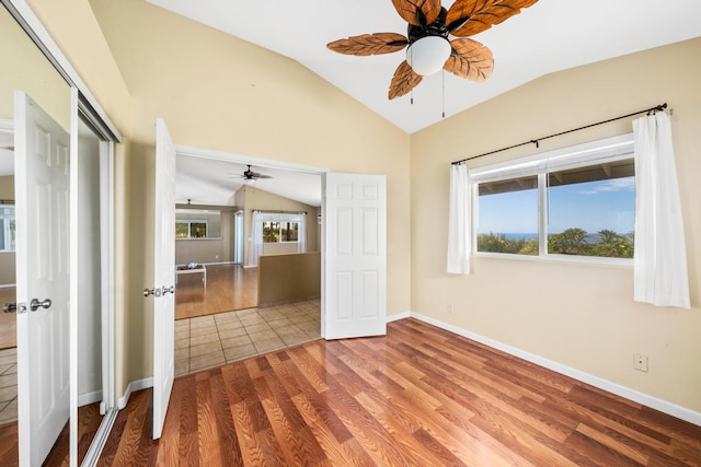 interior space with lofted ceiling, hardwood / wood-style floors, a closet, and ceiling fan