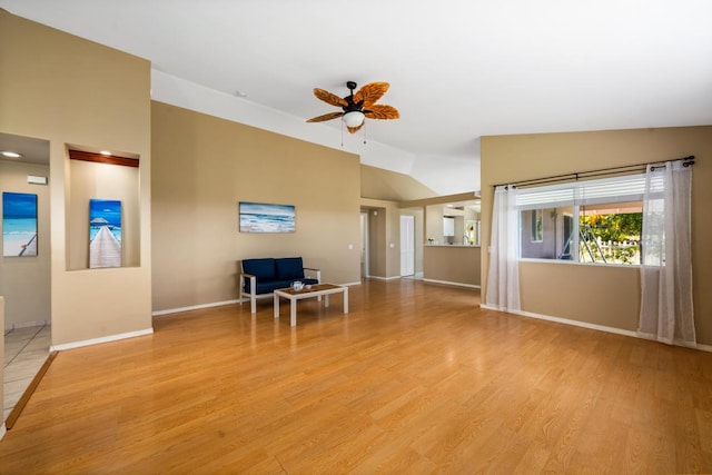 unfurnished living room with light hardwood / wood-style floors, lofted ceiling, and ceiling fan