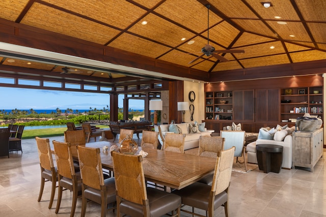 dining space with ceiling fan, built in features, wooden ceiling, vaulted ceiling, and a water view