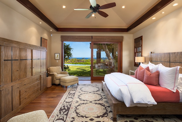 bedroom with access to outside, a raised ceiling, ceiling fan, and light hardwood / wood-style flooring