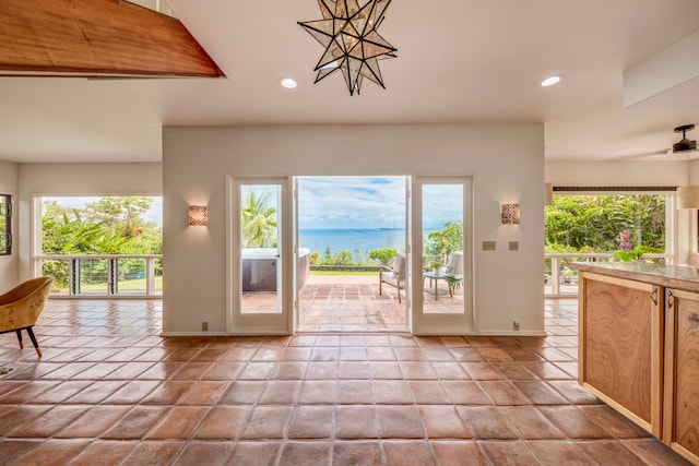 entryway featuring light tile patterned flooring and ceiling fan