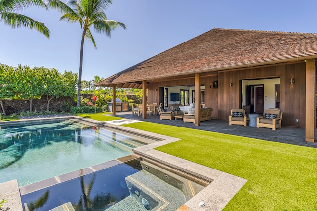 view of swimming pool with a lawn, a patio, an outdoor living space, and an in ground hot tub