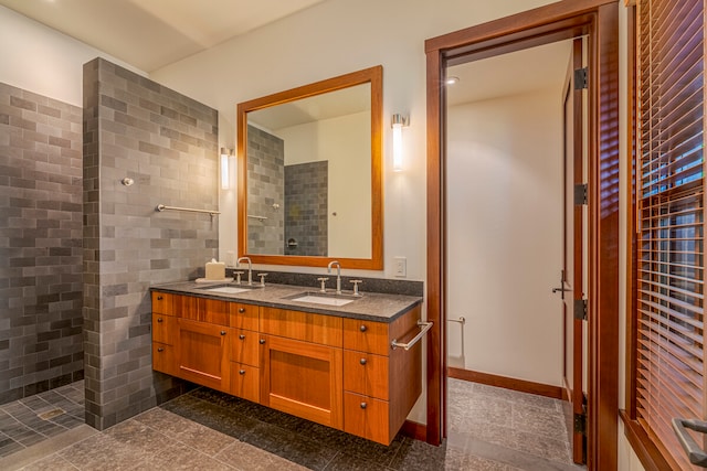 bathroom with a tile shower, tile walls, and vanity