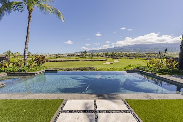 73-4839 Maia Loop Unit 40, Kailua-Kona, HI 96740 - view of pool featuring a mountain view, view of golf course, a pool with connected hot tub, and a lawn