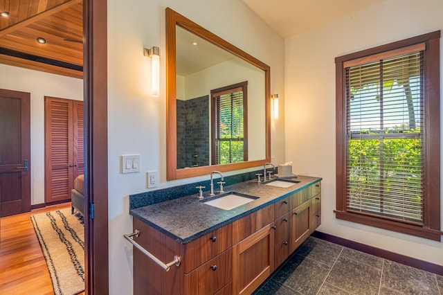 bathroom with a healthy amount of sunlight, wood ceiling, vanity, and hardwood / wood-style flooring