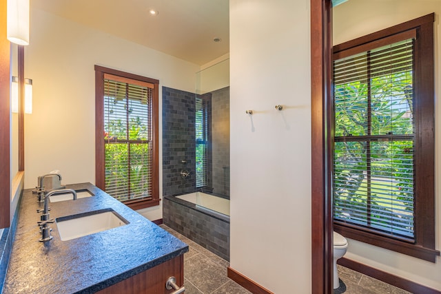 bathroom featuring vanity, toilet, and plenty of natural light