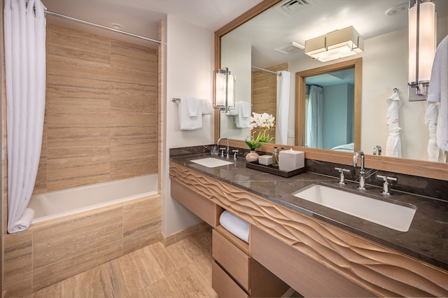 bathroom with shower / tub combo with curtain, vanity, and tile patterned floors