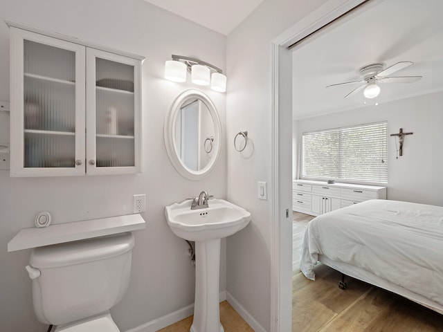 bathroom featuring toilet, hardwood / wood-style flooring, sink, and ceiling fan