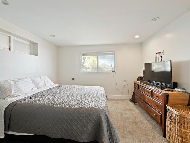 bedroom featuring light carpet