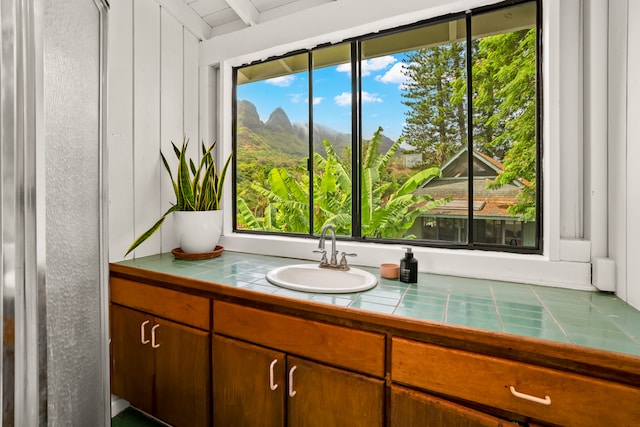 bathroom with vanity and beamed ceiling