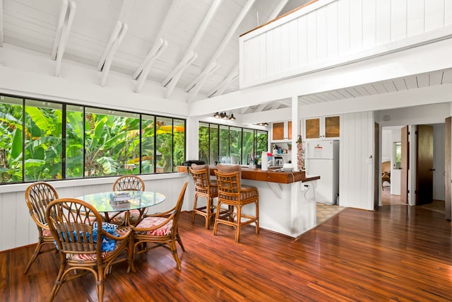 sunroom / solarium with vaulted ceiling with beams