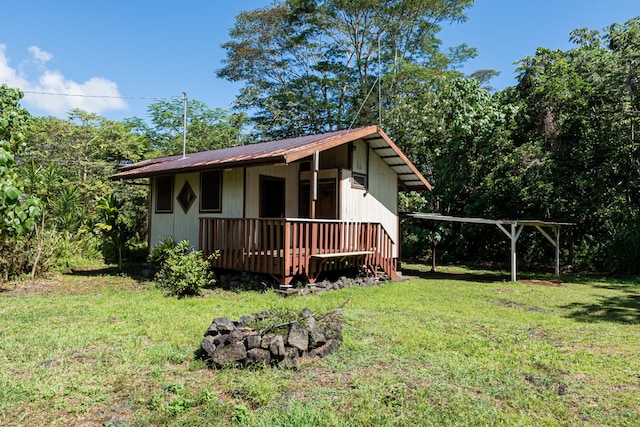 exterior space featuring a wooden deck and a lawn