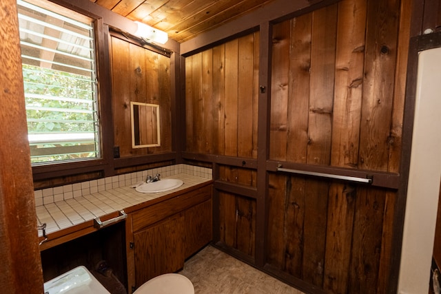 bathroom with wood ceiling, vanity, and toilet