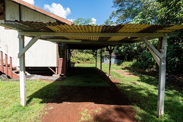 view of yard with a storage shed and a carport