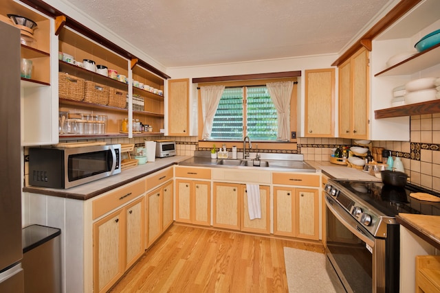 kitchen featuring light brown cabinets, decorative backsplash, appliances with stainless steel finishes, light hardwood / wood-style flooring, and sink