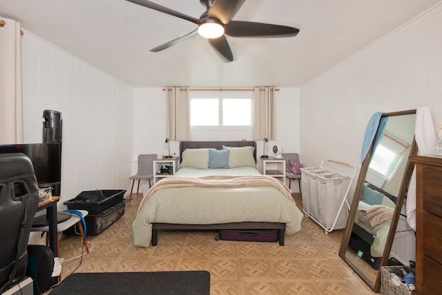 bedroom featuring crown molding, light parquet flooring, and ceiling fan