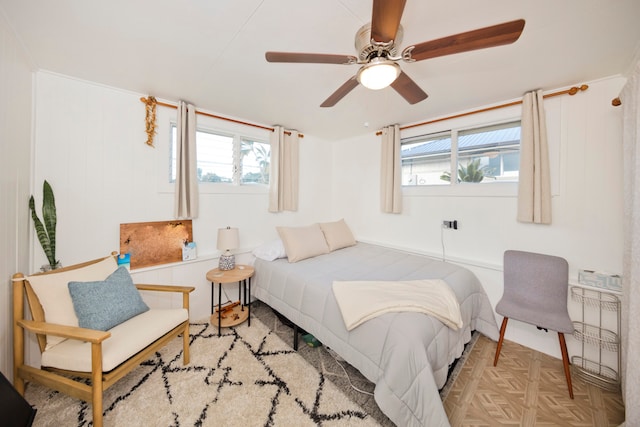 bedroom with light parquet floors and ceiling fan