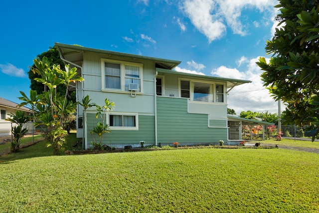 rear view of house with a lawn