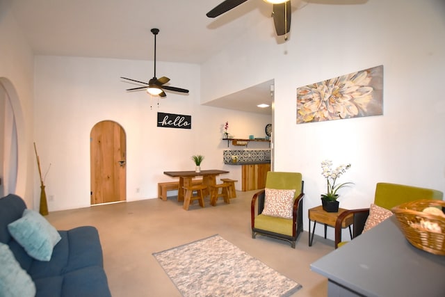 living room featuring high vaulted ceiling and ceiling fan