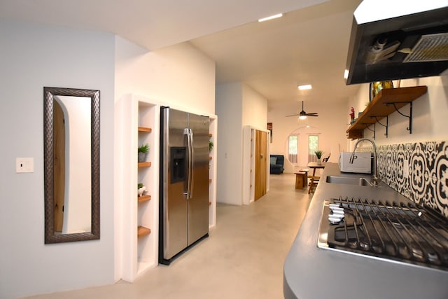 kitchen featuring stainless steel fridge, sink, ceiling fan, and exhaust hood