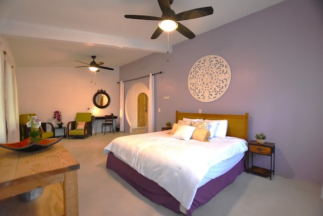 carpeted bedroom with beamed ceiling and ceiling fan