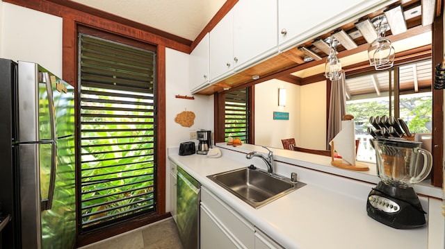 kitchen with white cabinets, appliances with stainless steel finishes, plenty of natural light, and sink