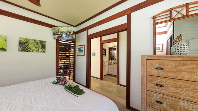 bedroom with crown molding and ensuite bathroom