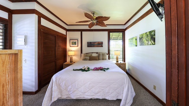 carpeted bedroom featuring a closet, ornamental molding, and ceiling fan