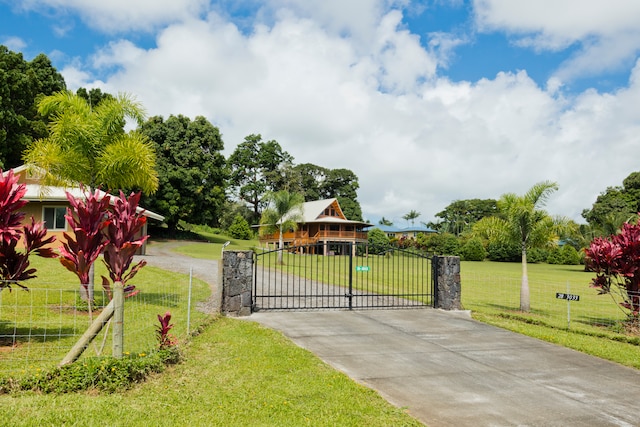 view of gate with a lawn