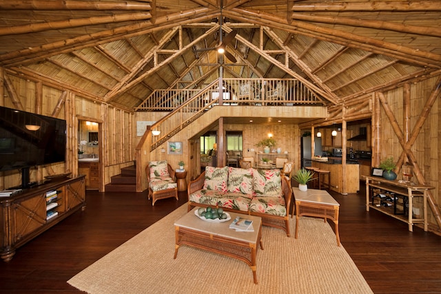 living room featuring wood walls, beam ceiling, high vaulted ceiling, dark hardwood / wood-style floors, and wooden ceiling