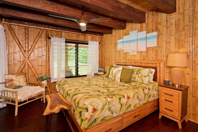 bedroom with access to outside, beamed ceiling, wood walls, and dark wood-type flooring