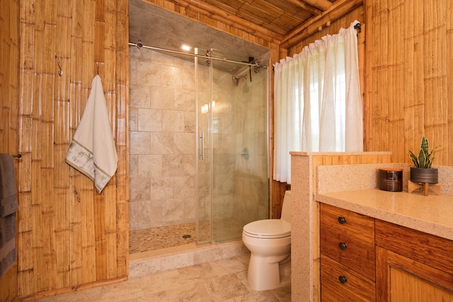 bathroom featuring wood walls, toilet, wooden ceiling, a shower with shower door, and vanity