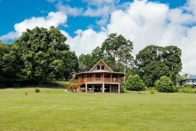 back of property featuring a lawn