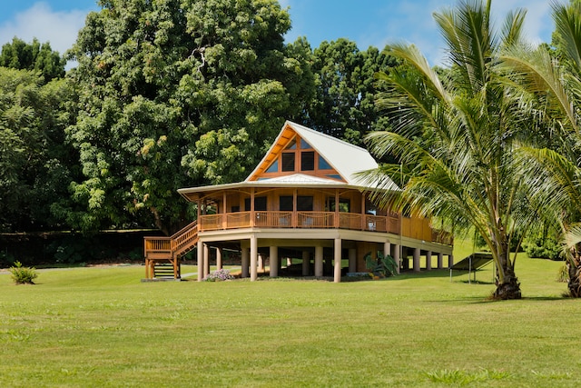 rear view of house featuring a lawn