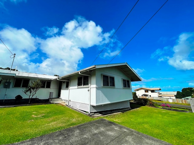 view of side of home with a lawn