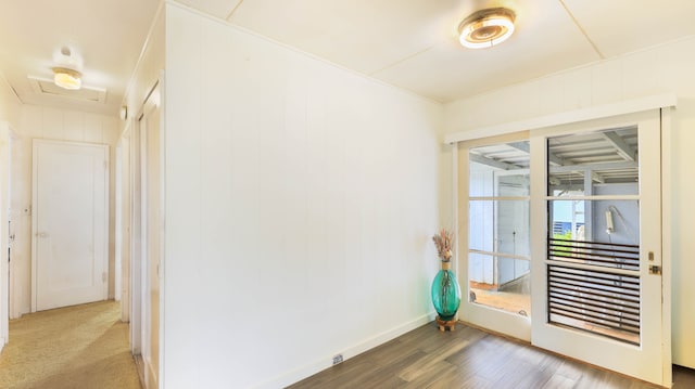 spare room with wood-type flooring and wooden walls