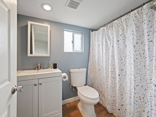 bathroom featuring vanity, hardwood / wood-style floors, toilet, and a shower with shower curtain