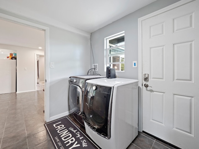 clothes washing area with tile patterned flooring and washing machine and dryer