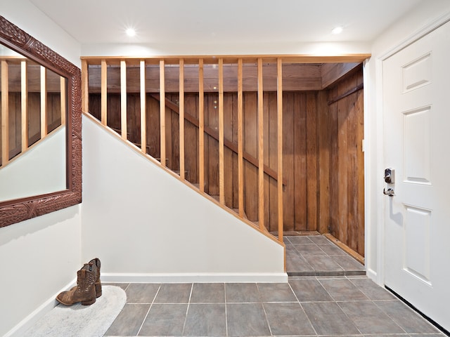 stairway with tile patterned floors