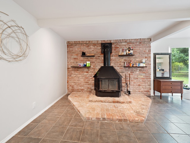 details featuring beamed ceiling, a wood stove, and tile patterned floors