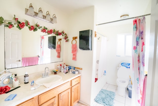 full bathroom with tile patterned floors, vanity, shower / tub combo, and toilet